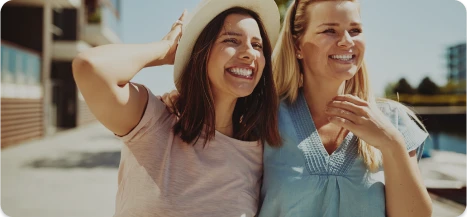 Smiling women talking together after confidence-boosting procedures – Ditesheim Cosmetic Surgery