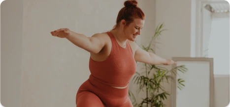 Confident woman stretching after breast reduction surgery – Ditesheim Cosmetic Surgery