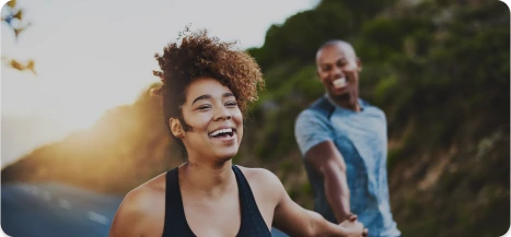 Woman smiling outdoors after surgery recovery – Ditesheim Cosmetic Surgery